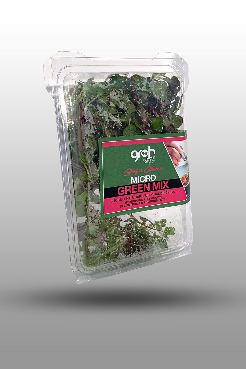 Chef in hotel or restaurant kitchen cooking, only hands. He is working on the micro herb decoration. Preparing tomato soup.